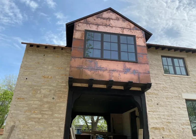 Copper metal panel facade on a stone building for Skylight Installation in Elk River