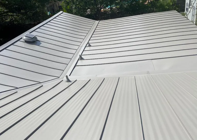Solar attic fan installed on a metal roof for Roof Ventilation in Elk River